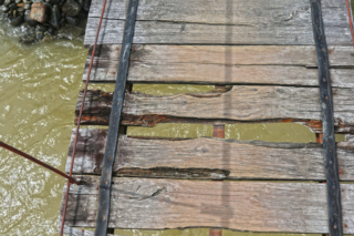 This bridge is still city-life standards and not some jungle bridge, but we already had to learn “mind your steps”. Bukit Lawang jungle trek thefreesurfer.com